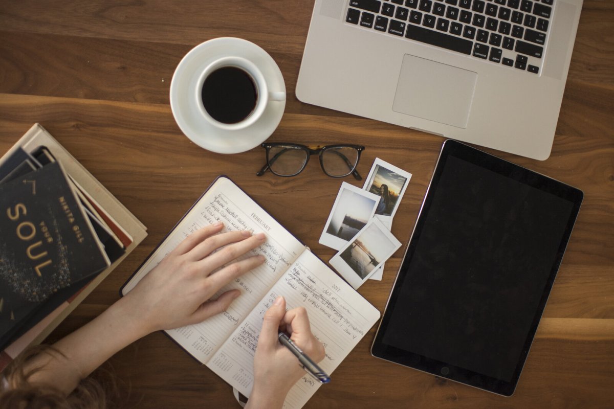 A journal and a cup of coffee on a desk